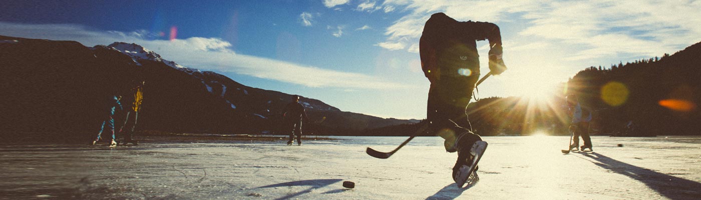 People playing hockey on outdoor rink