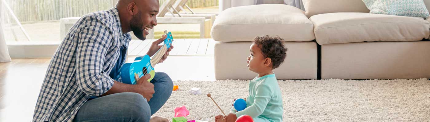 Adult and toddler playing toy instruments