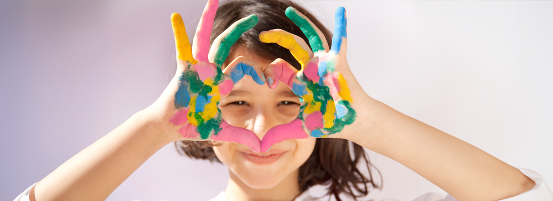 child's painted hands in the shape of a heart