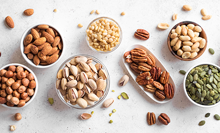 Overhead image of nuts and seeds in bowls